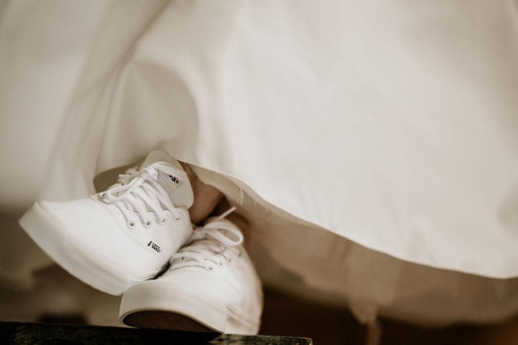 close up image of brides sneakers and dress during colorado micro wedding.