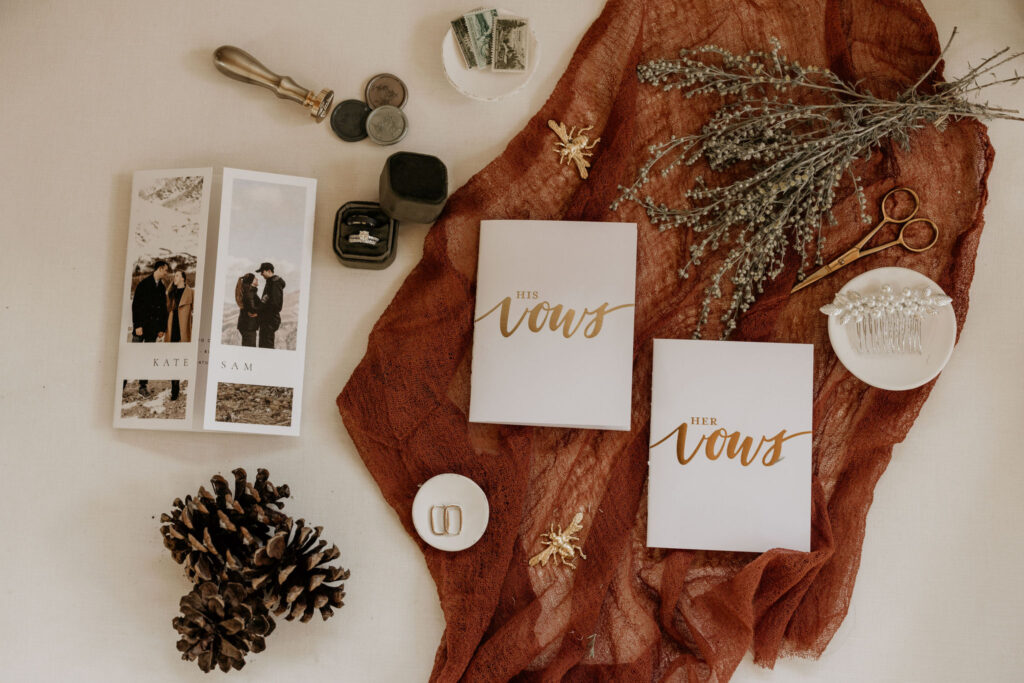 wedding details are set out as a flat lay during a mountain top micro wedding in colorado.