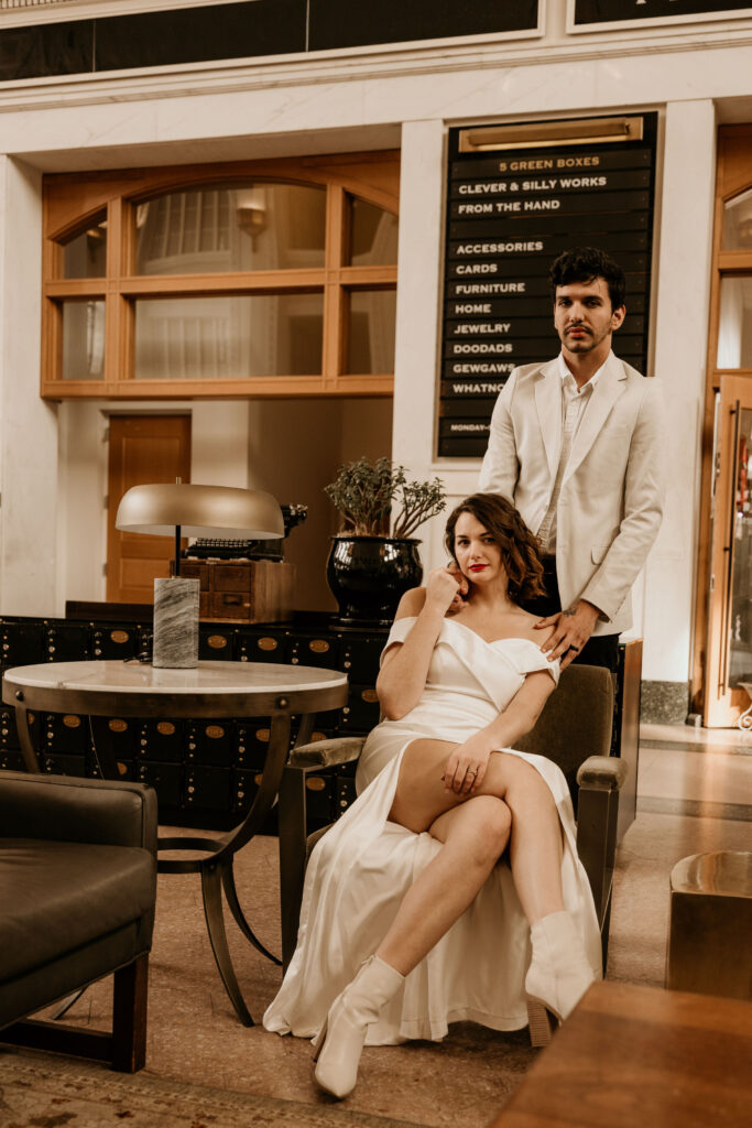 Bride and groom pose in denver union station during their winter urban elopement in Colorado.