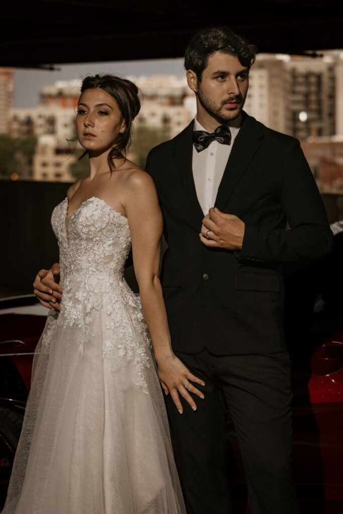 bride and groom stand and pose in parking garage during colorado bridal portrait session.
