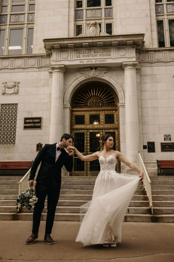 Newlywed couple dances outside of downtown denver courthouse during urban elopement.