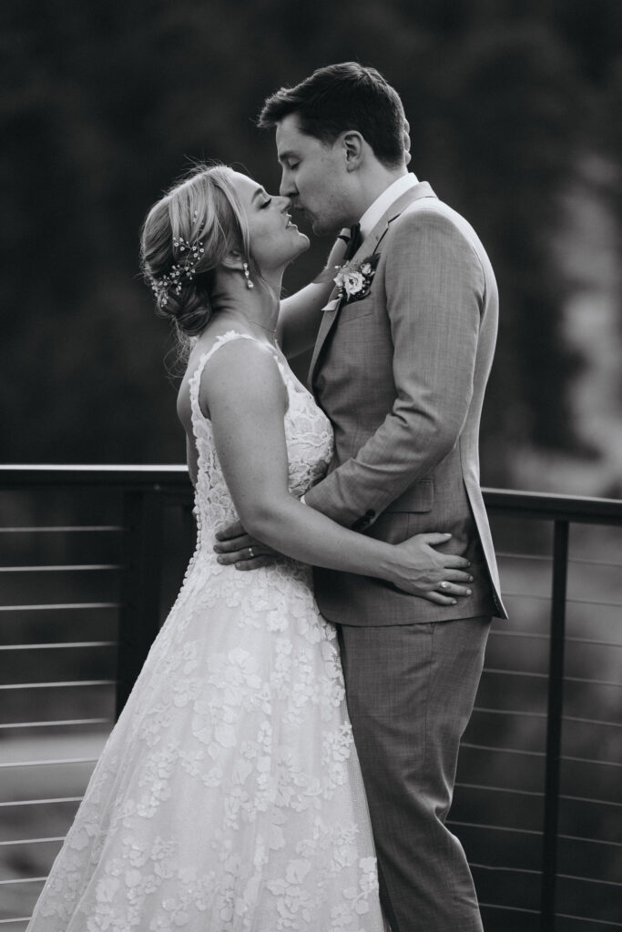 black and white image of bride and groom kissing during mountain wedding in colorado.