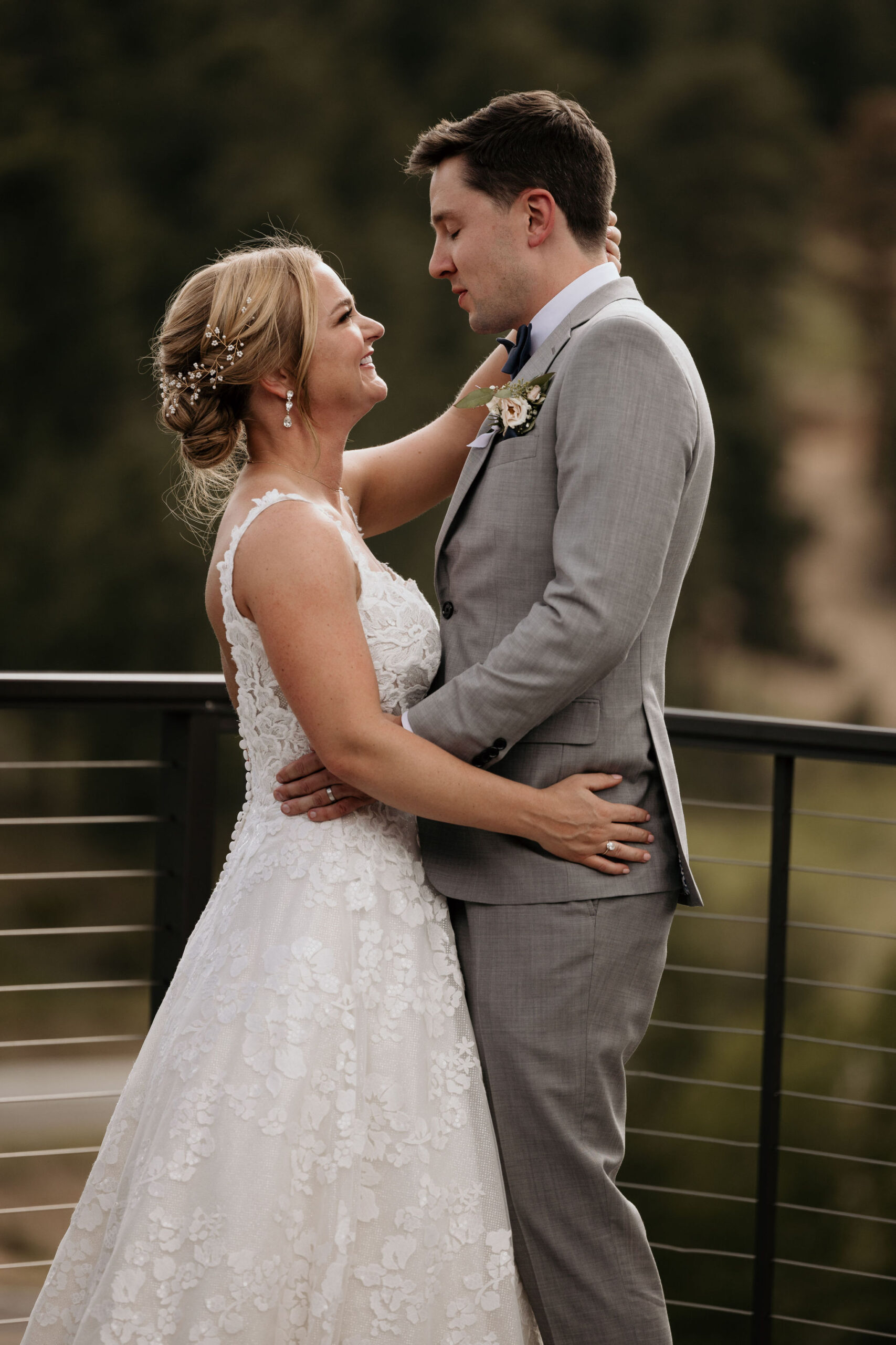 bride and groom smile and look at each other during wedding ceremony at skyview venue in estes park colorado.