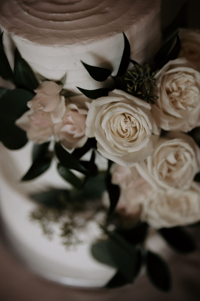 close up image of white cake with flowers during a colorado mountain wedding in estes park.