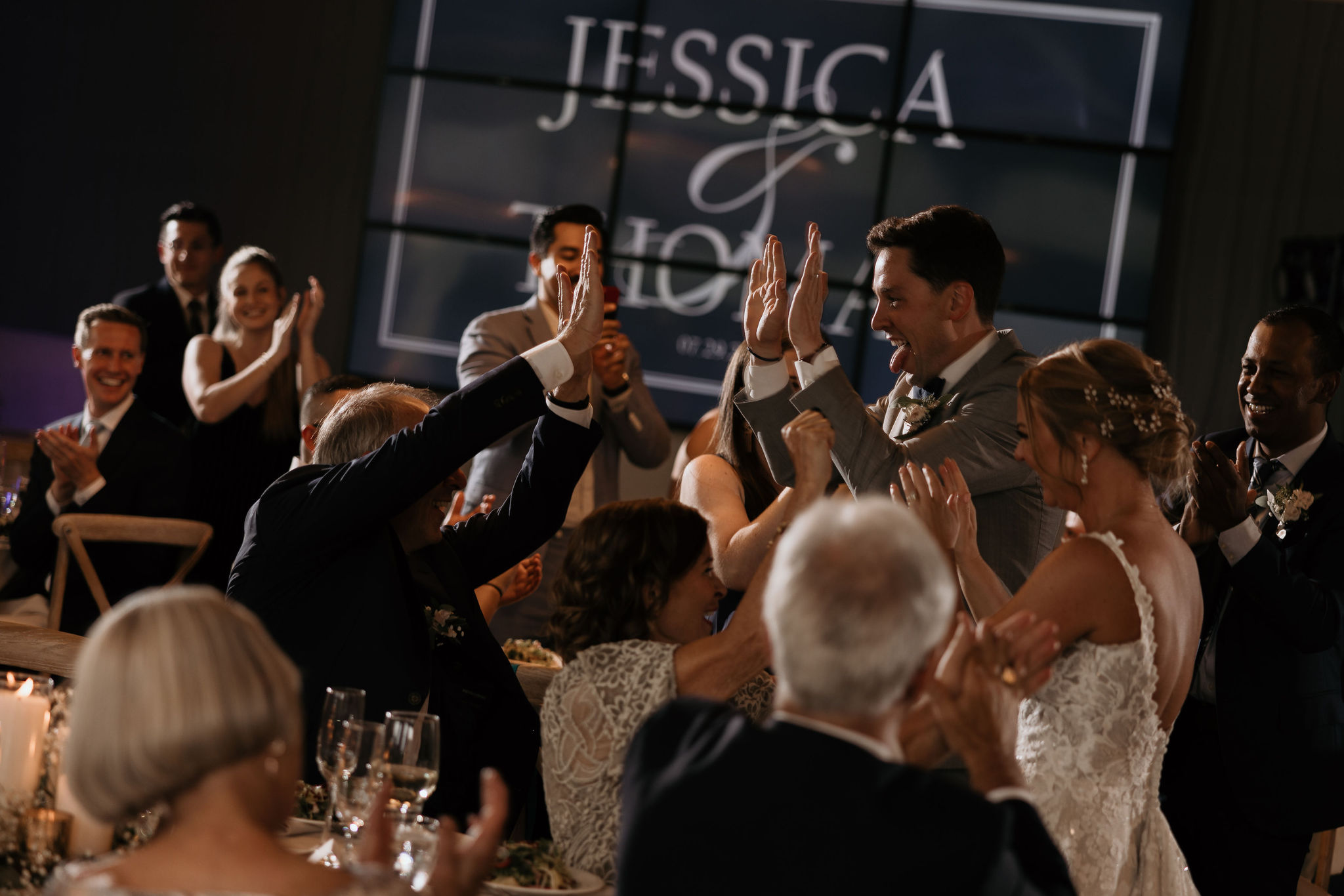bride and groom high five guests at their colorado wedding reception at skyview venue in estes park.