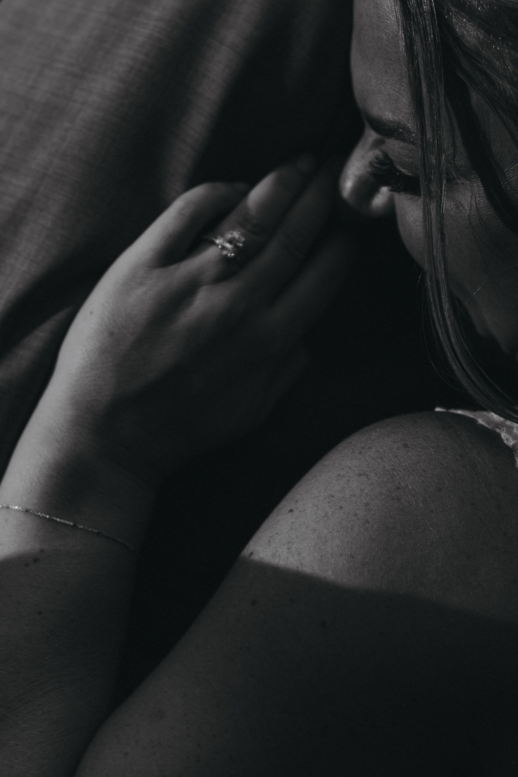 black and white image of bride and her ring, against the grooms jacket, during colorado wedding in estes park.