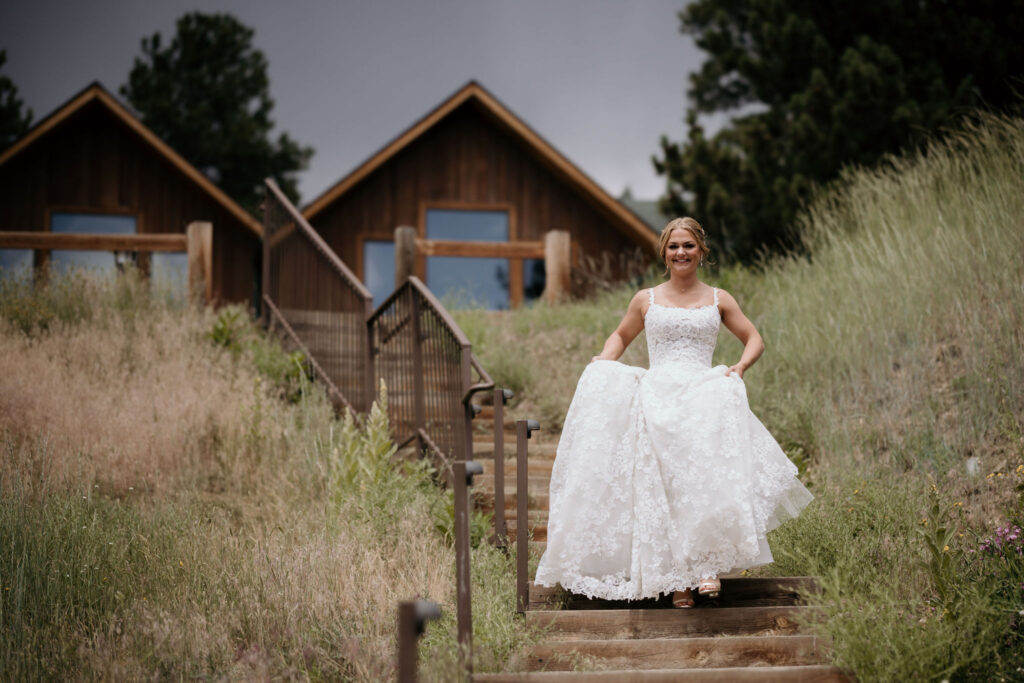 bride walks down sidewalk during colorado mountain wedding at skyview venue.