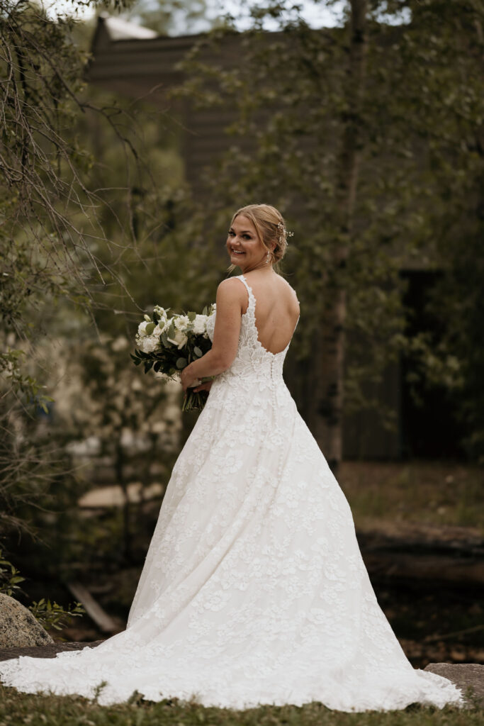bride turns around and smiles during her bridal portraits at skyview wedding venue in colorado.