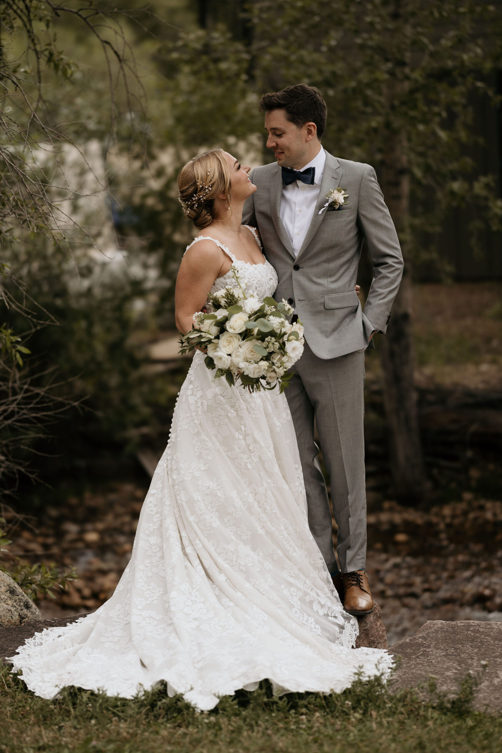 bride and groom look at each other and smile during their colorado mountain wedding in estes park.