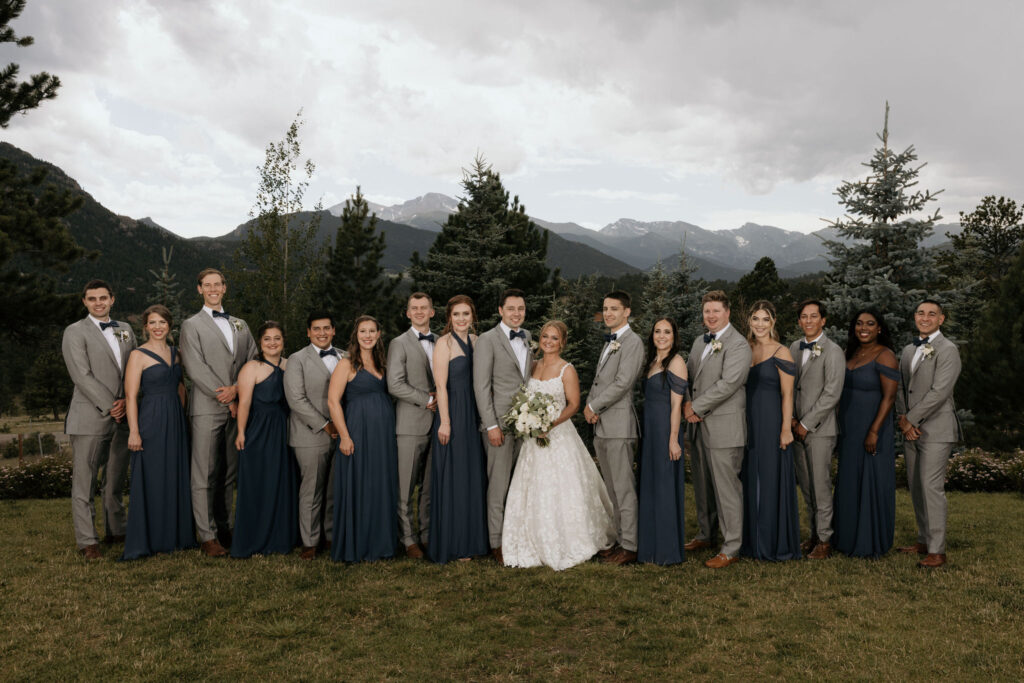 wedding party poses at the stanley hotel for wedding portraits in estes park colorado.