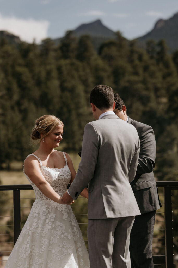bride and groom, with mountains in the background, during their colorado mountain wedding ceremony at skyview venue.