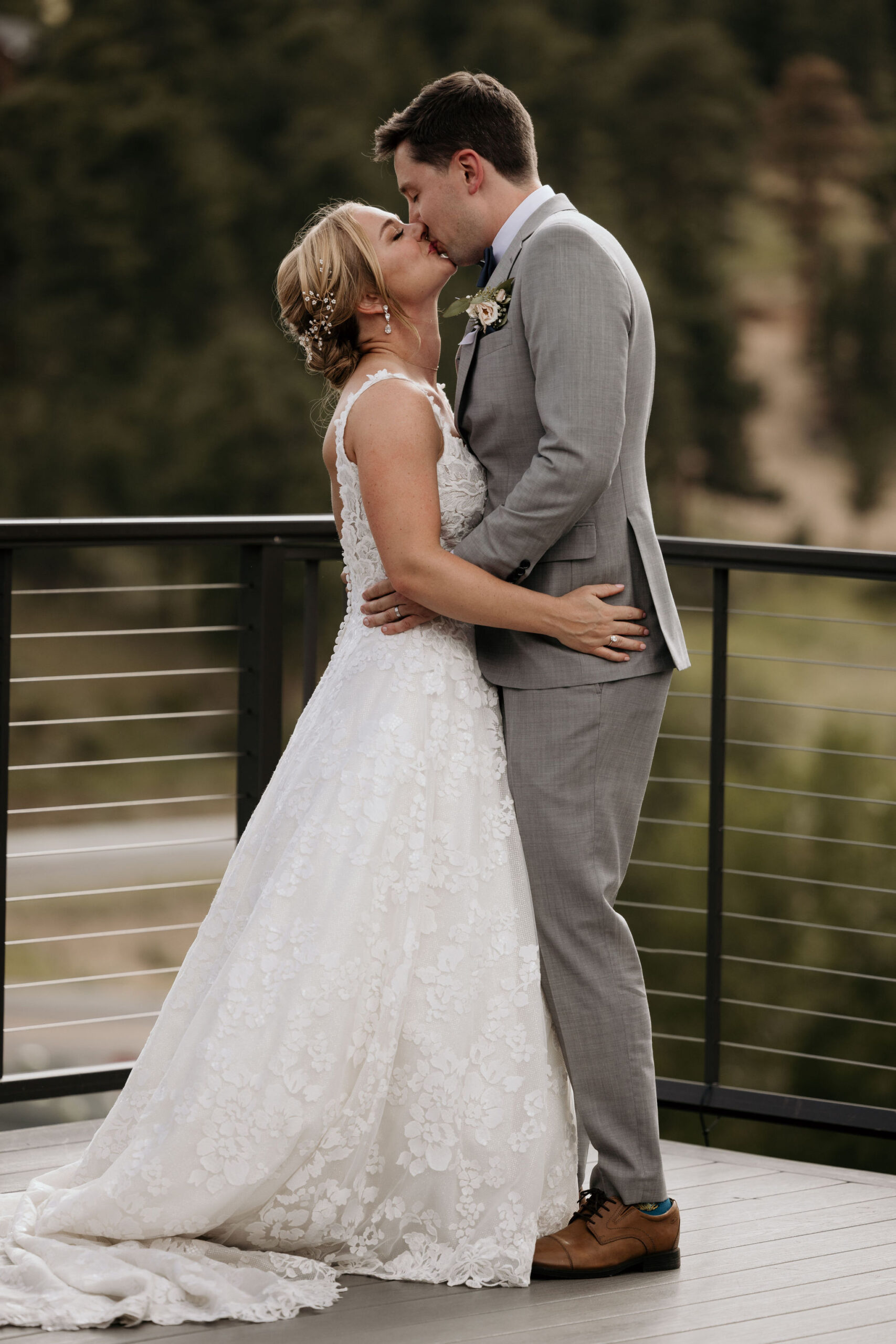 bride and groom kiss during wedding ceremony in estes park colorado.