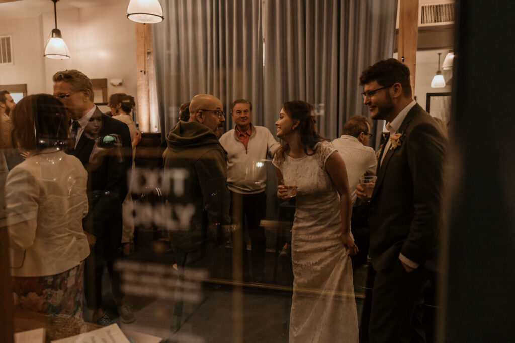 bride and groom mingle with guests inside of downtown denver restaurant for Colorado reception.