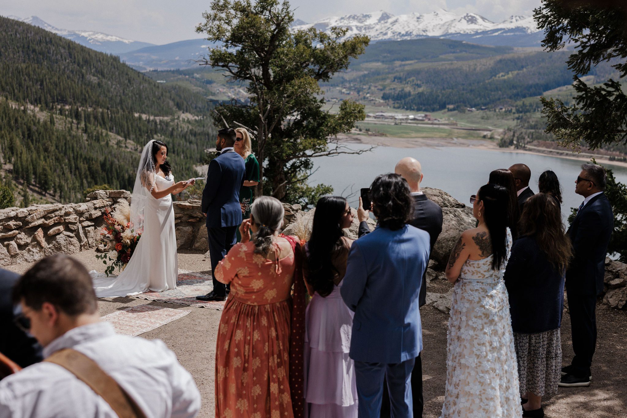 bride and groom say wedding vows in front of guests at micro wedding in colorado