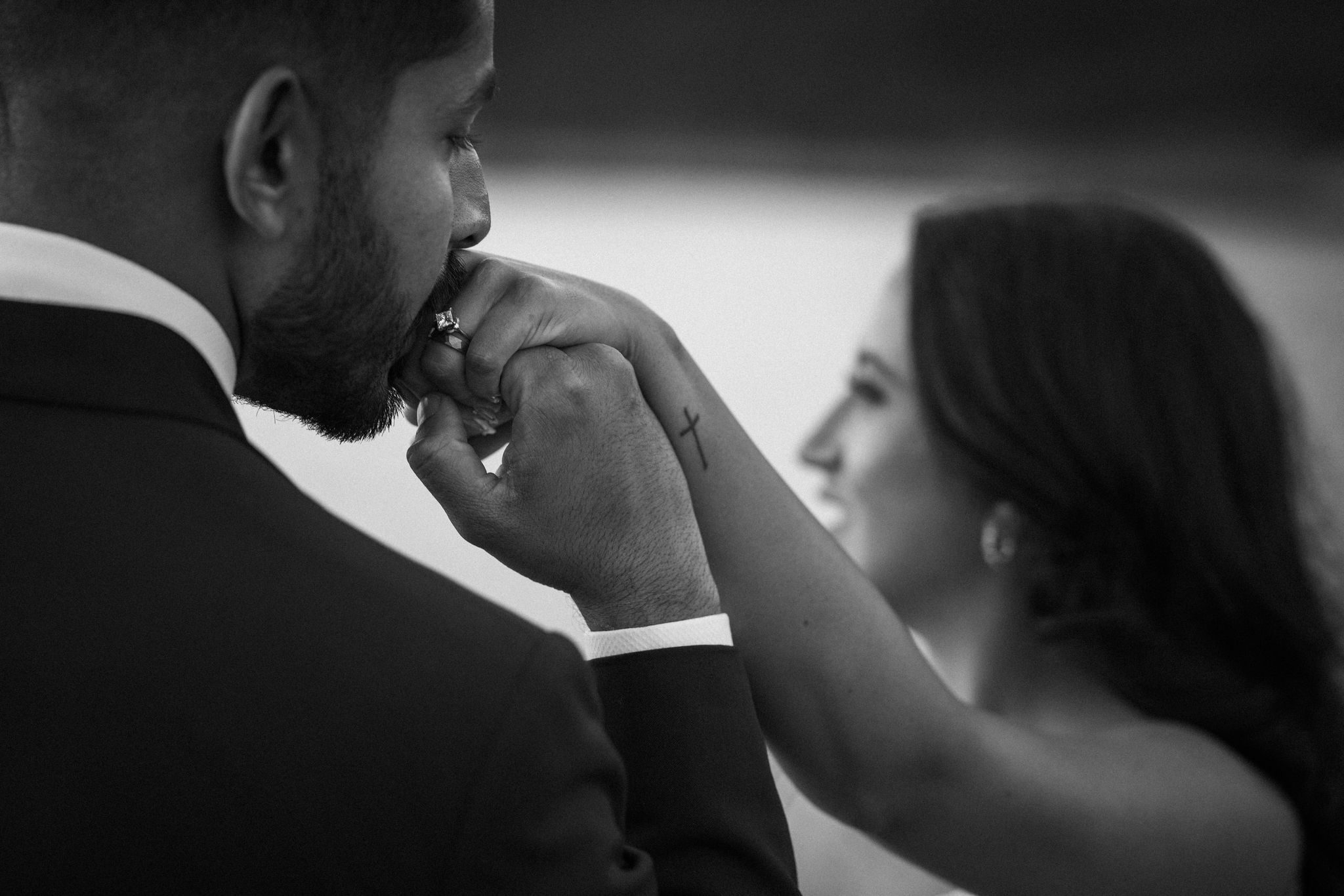 groom kisses brides wedding ring after shopping for a sustainable wedding ring