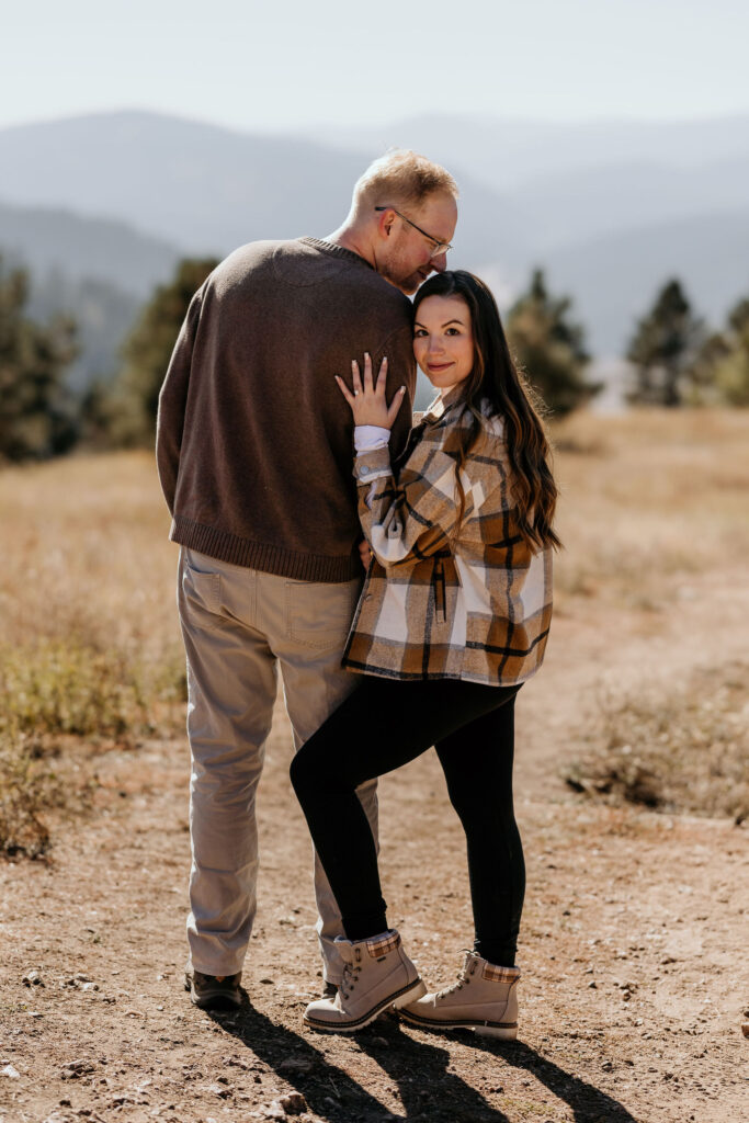 man and woman pose for colorado photographer during engagement photos.