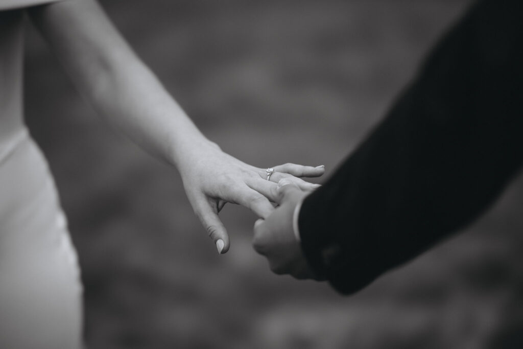 close up image of bride and groom's hands during a colorado mountain wedding.