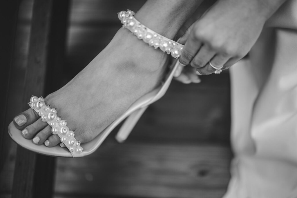 close up image of wedding shoes with pearls.