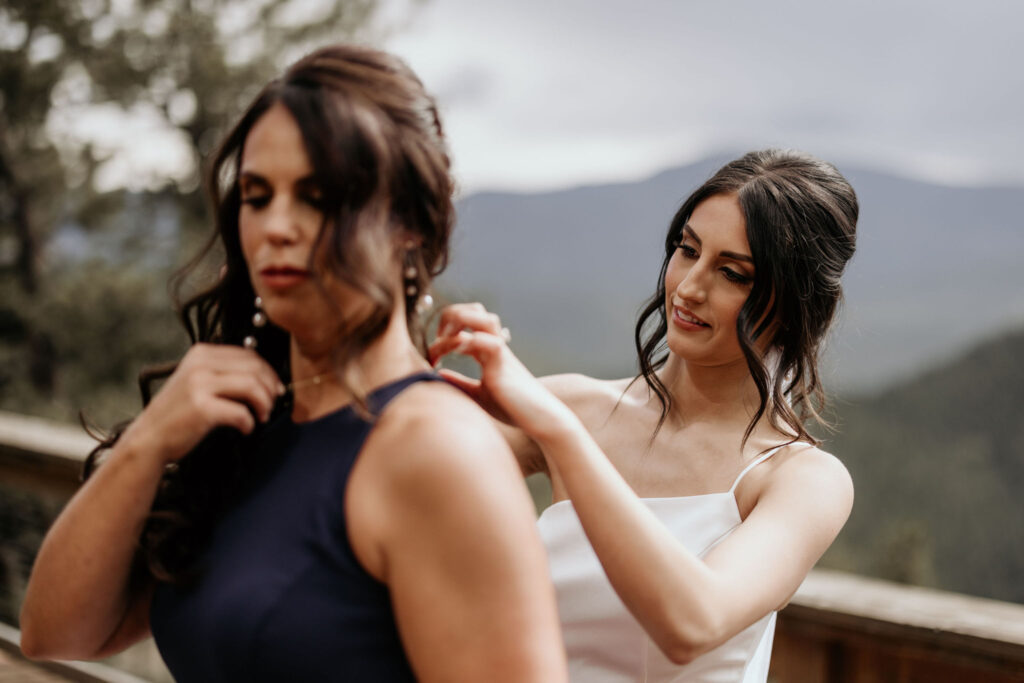 bride puts necklace on her mother at a colorado airbnb.