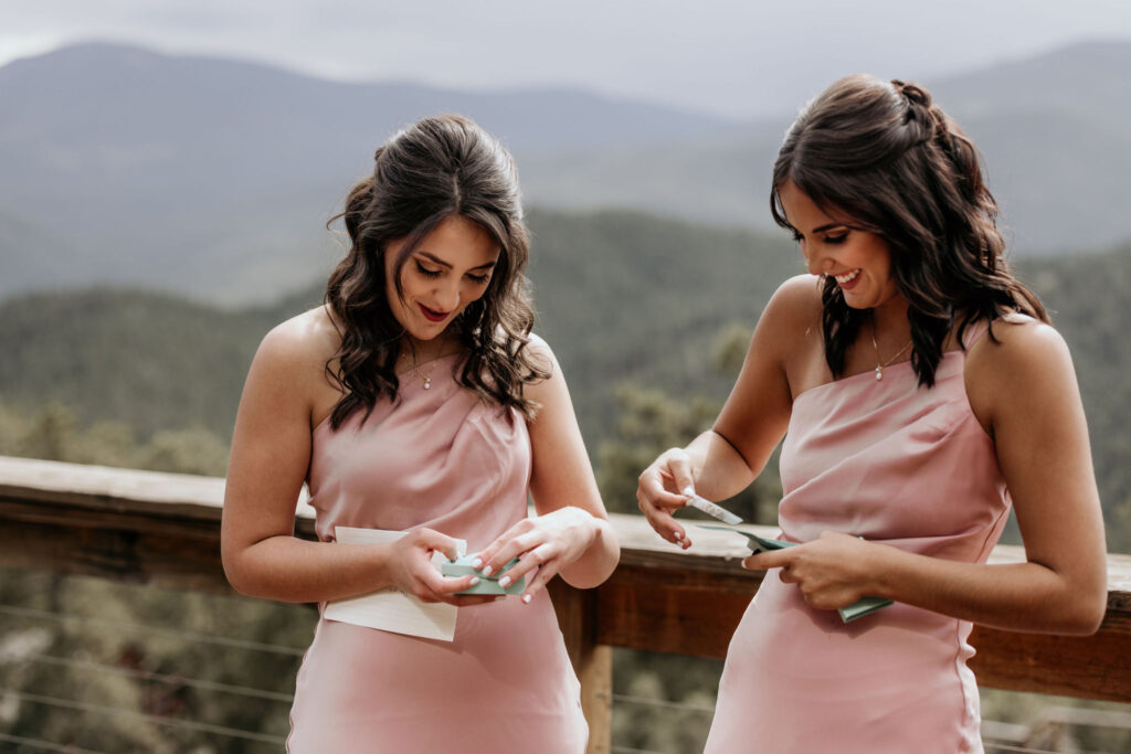 bridesmaids open personal gifts on the deck of an airbnb in colorado.