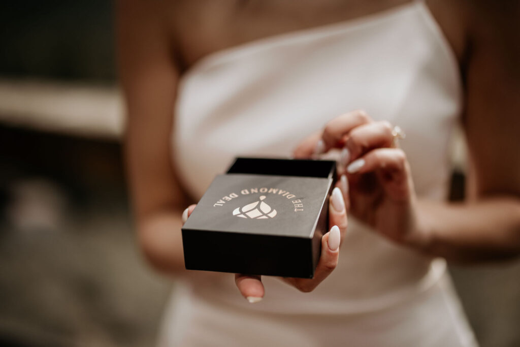bride opens wedding gift from husband before the ceremony.