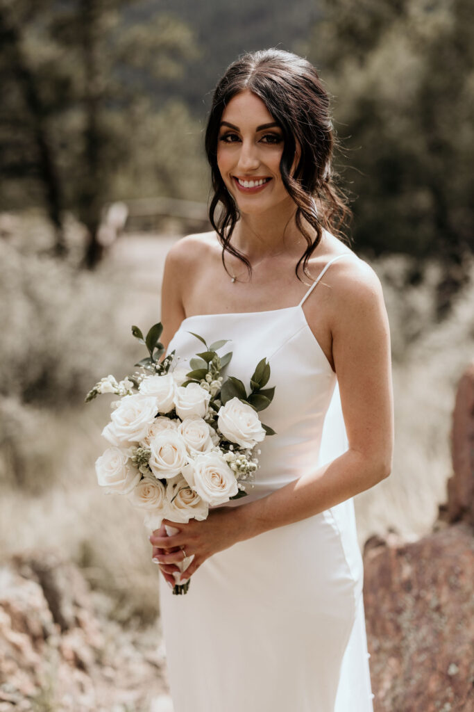 bride poses for colorado micro wedding photographer at an airbnb.