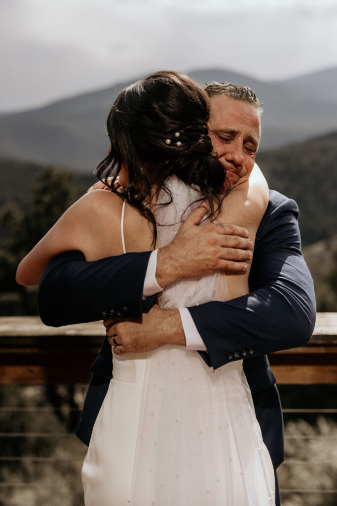 brides father hugs her during her wedding day in colorado.