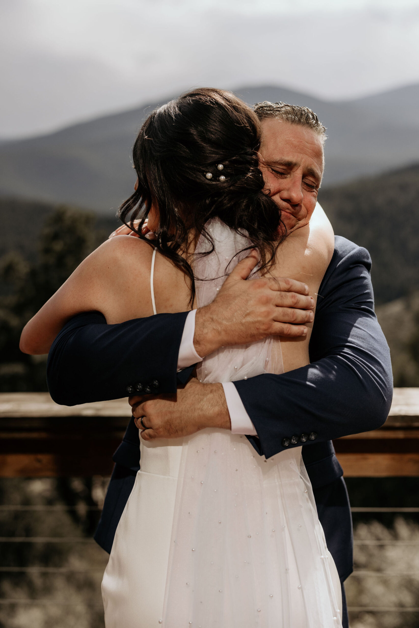 brides father hugs her during her micro wedding day in colorado.