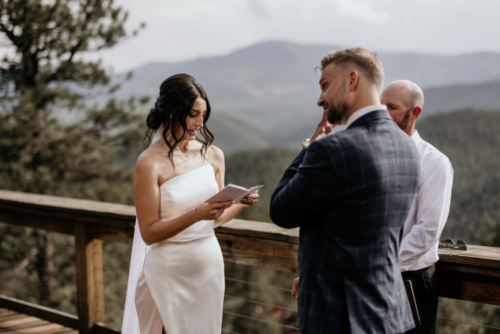 bride reads self-written vows to groom during wedding ceremony.