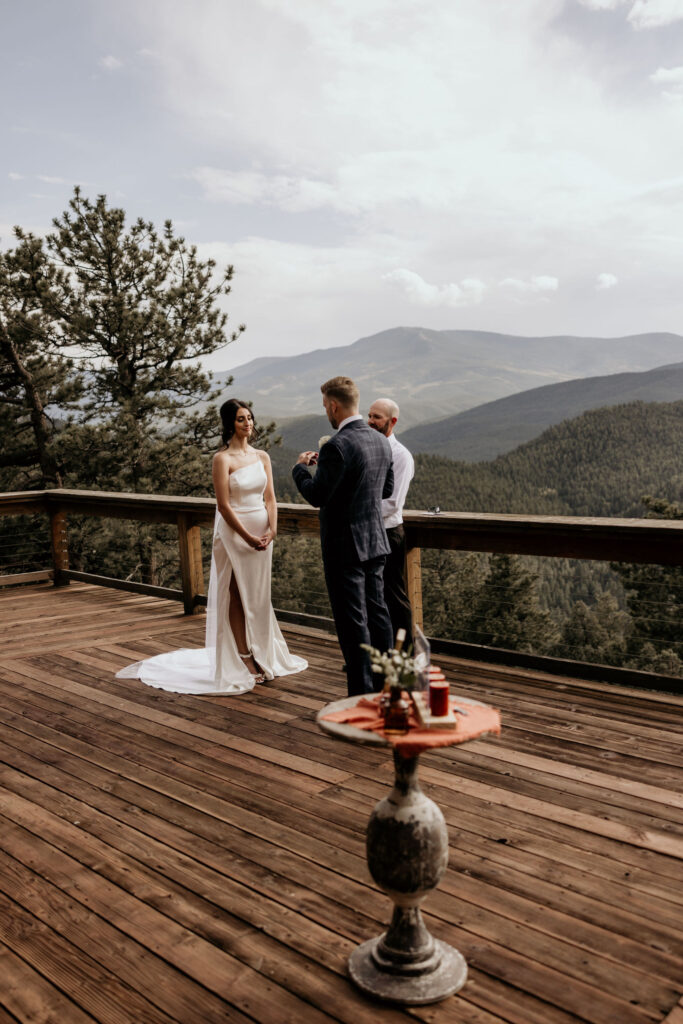 groom reads vows to bride during airbnb elopement.