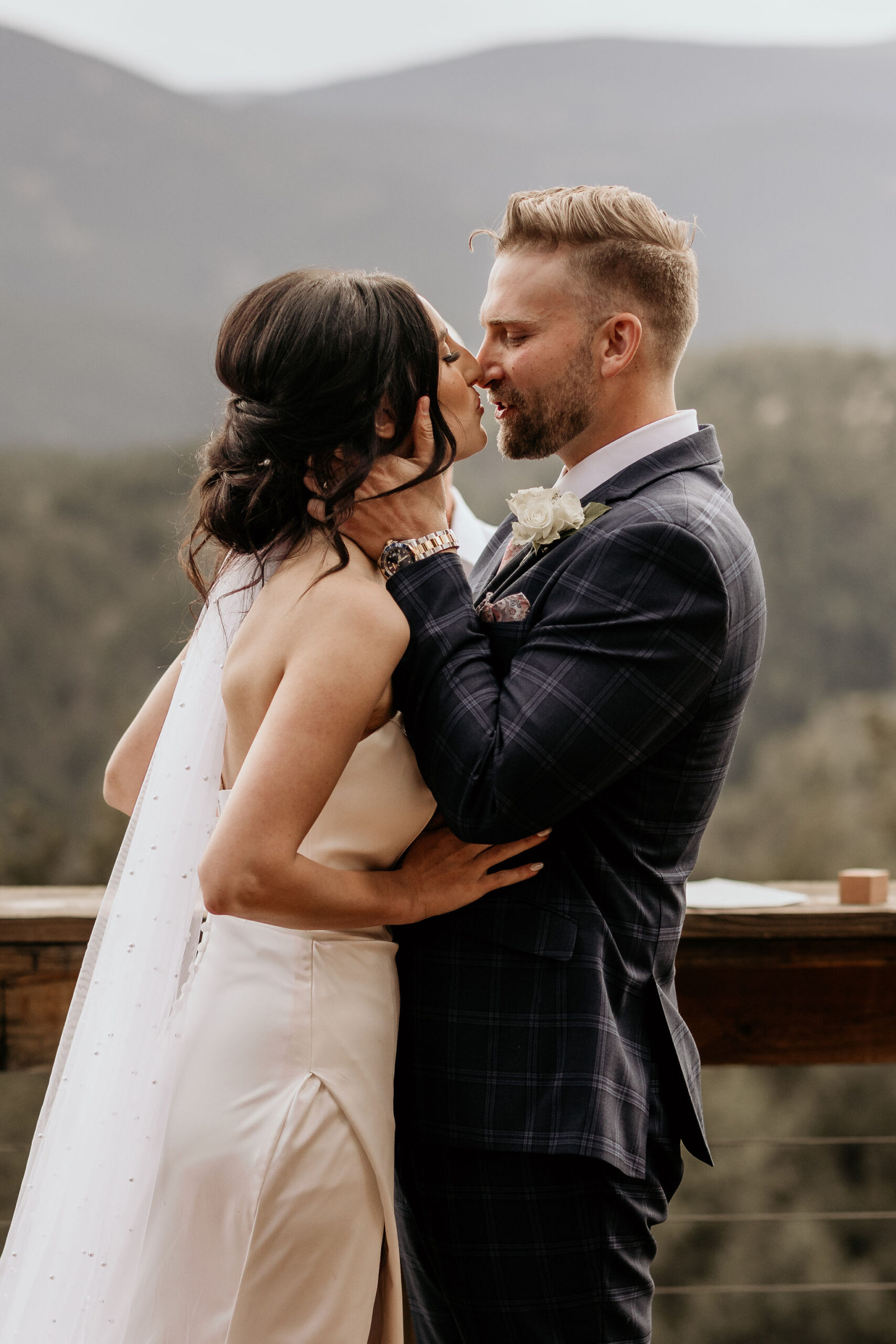 bride and groom go in for a kiss at their micro wedding in colorado.