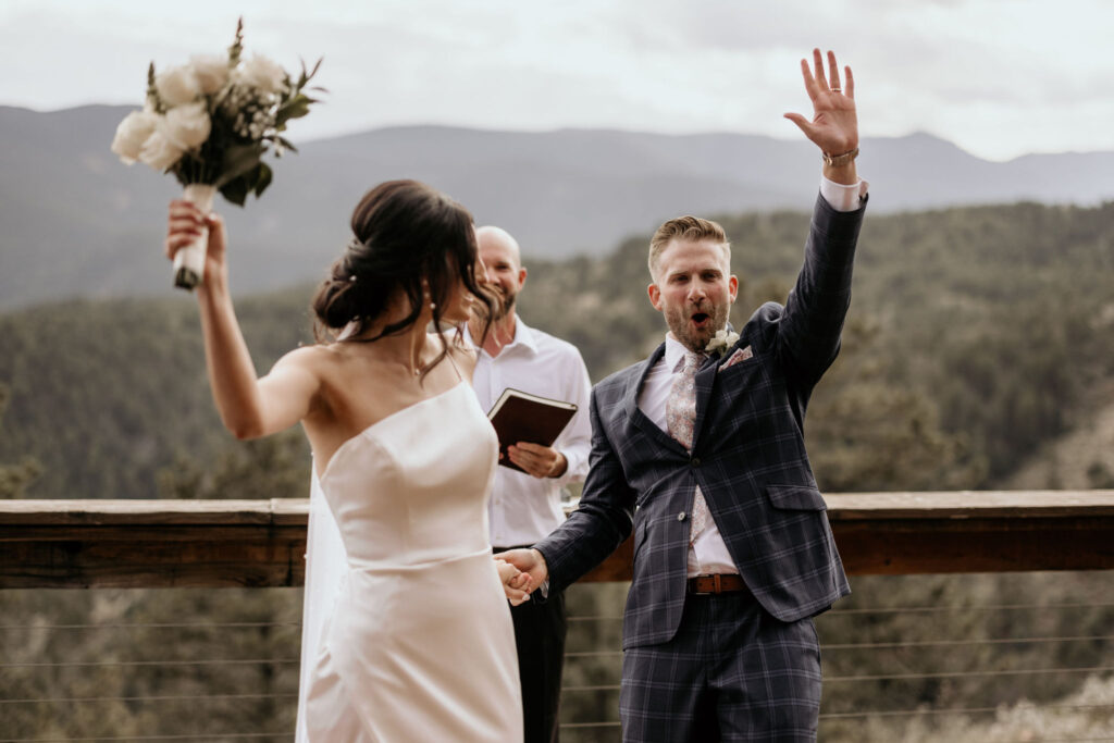 bride and groom celebrate as they walk down the aisle at a colorado airbnb wedding.