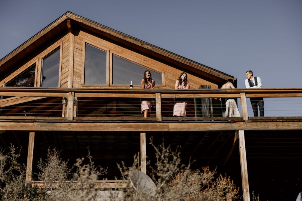 micro wedding guests enjoy cocktail hour at a colorado mountain airbnb.