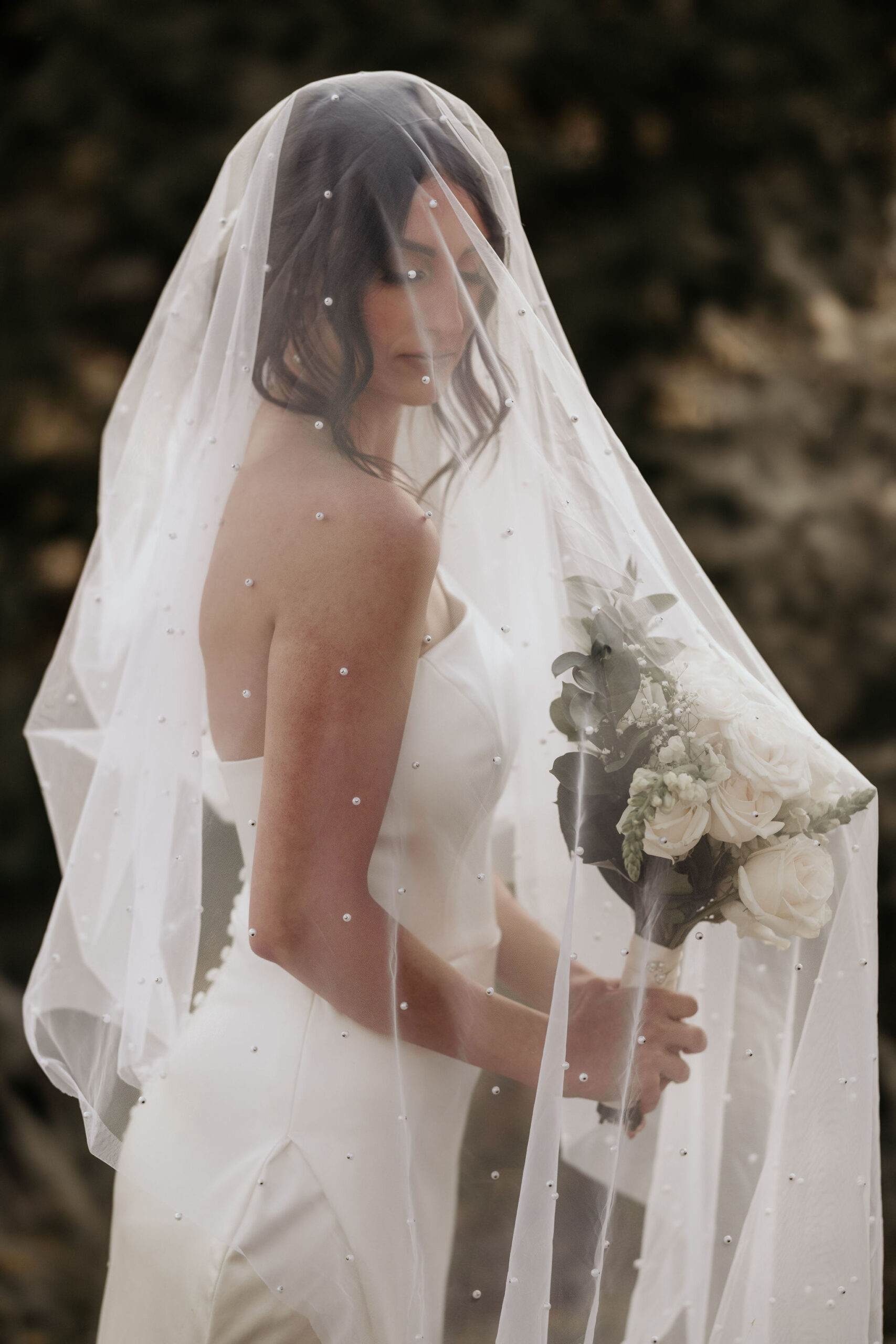 bride poses under veil for colorado micro wedding photographer.