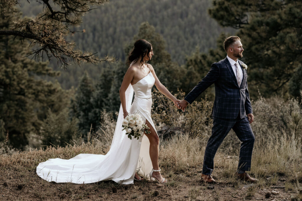 bride and groom pose for elopement photographer in the colorado mountains.