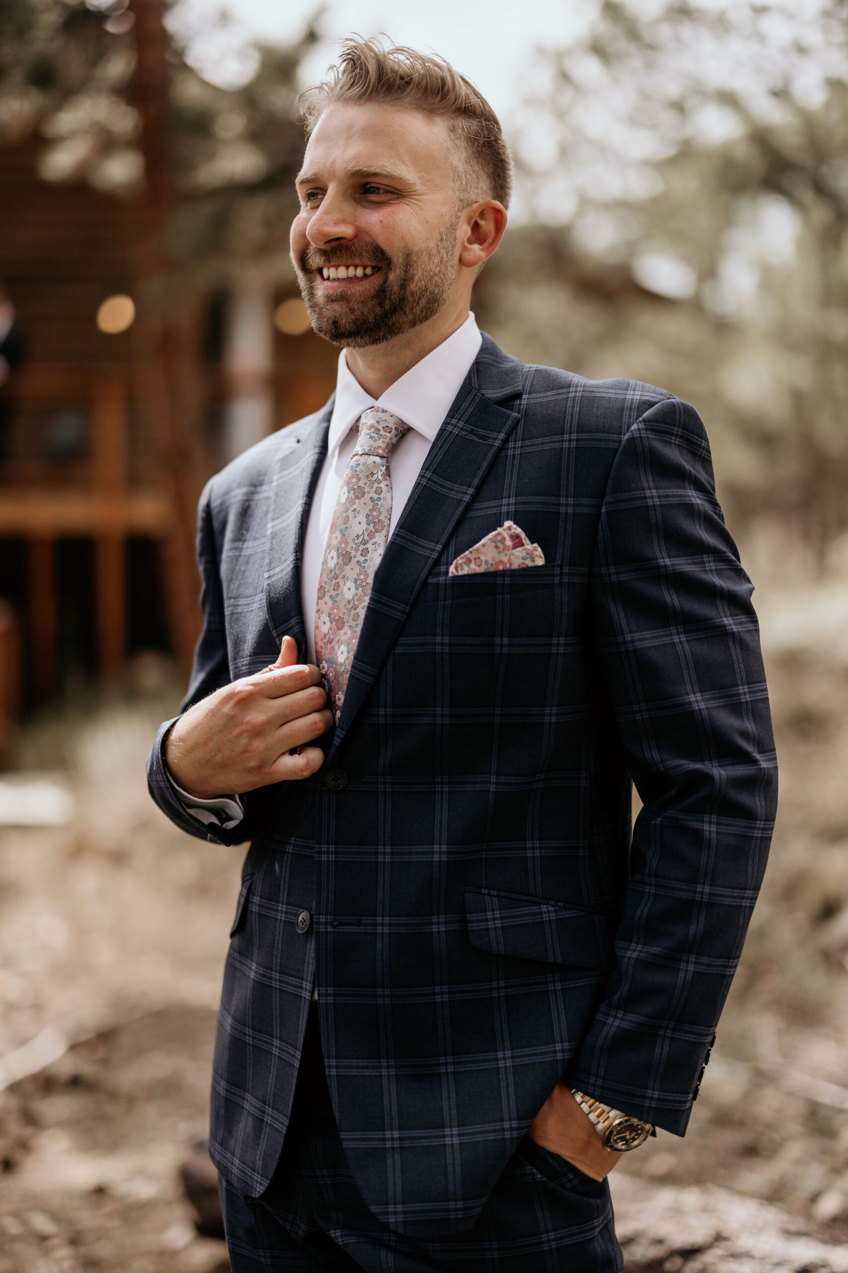 groom poses for photographer during colorado micro wedding