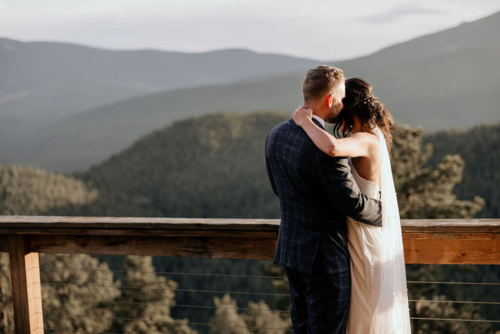 bride and groom dance on the deck of an airbnb during their colorado micro wedding.