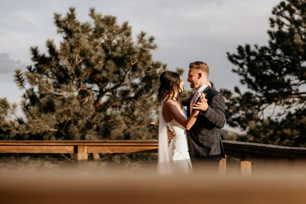 bride and groom share a first dance on the deck of an airbnb.