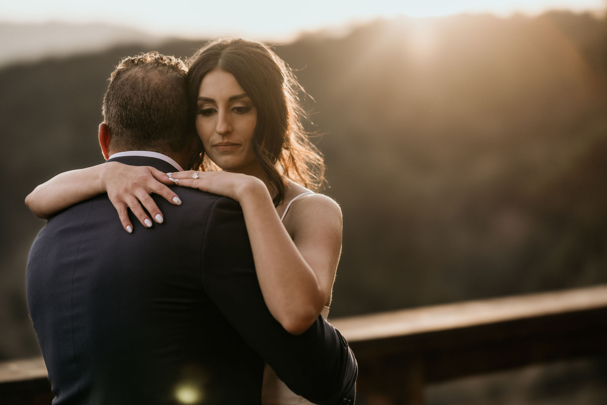 bride and her father dance during sunset on the deck of their rental, at her colorado micro wedding.