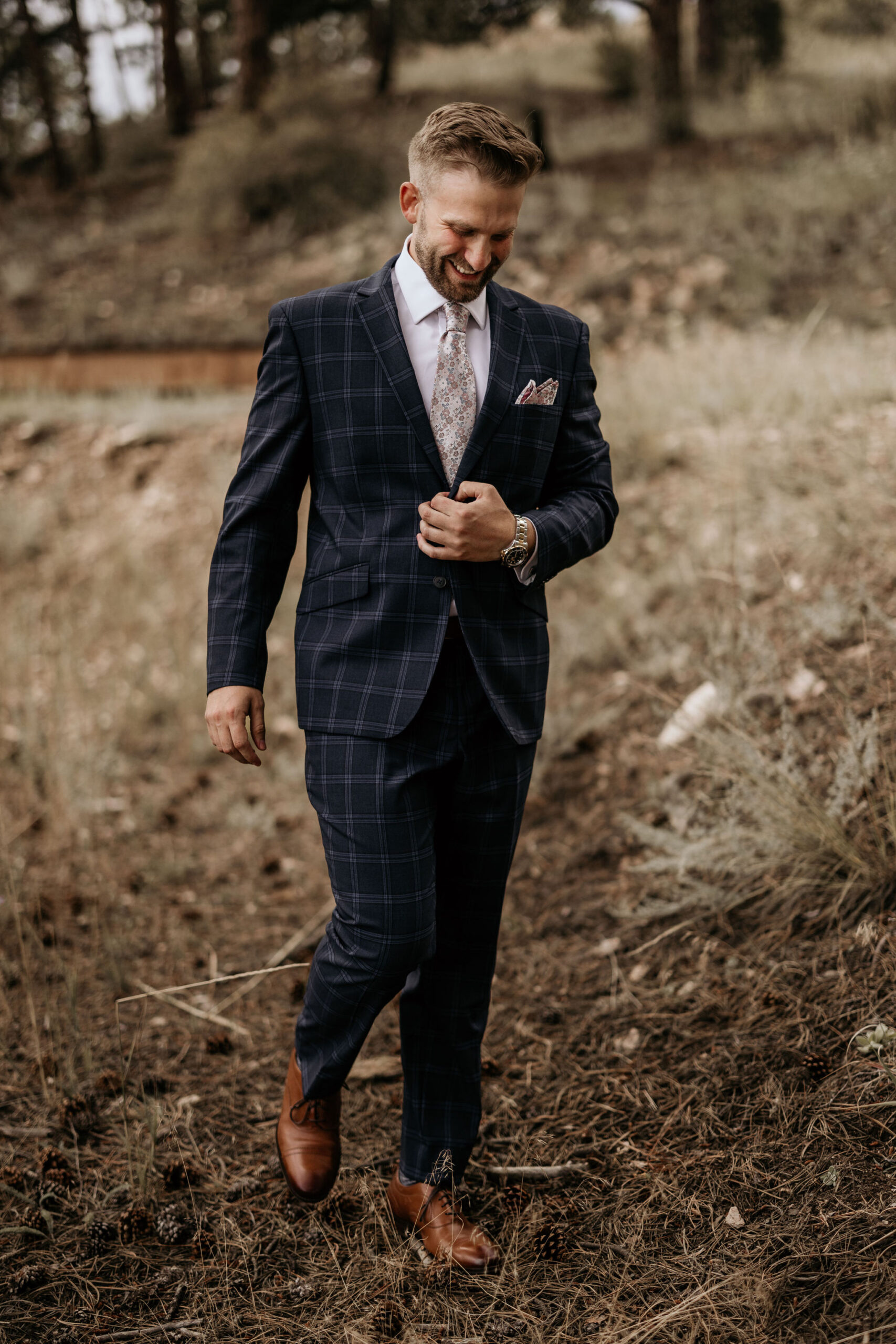 groom smiles as he walks down the trail to go see his bride for the first time