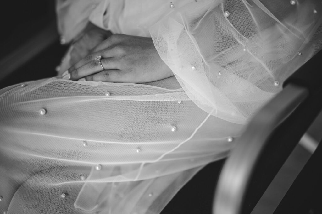 close up image of bride in her robe with pearls on it.