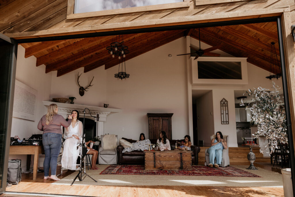 bride and her crew get ready in open air airbnb in the mountains.
