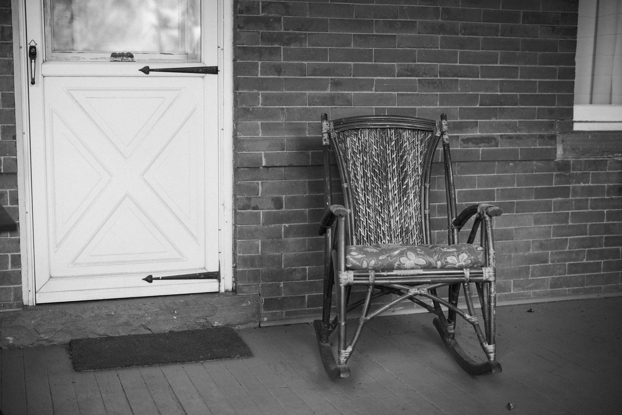 black and white photo of a chair sitting on a porch: it represents how it feels to plan a wedding while grieving