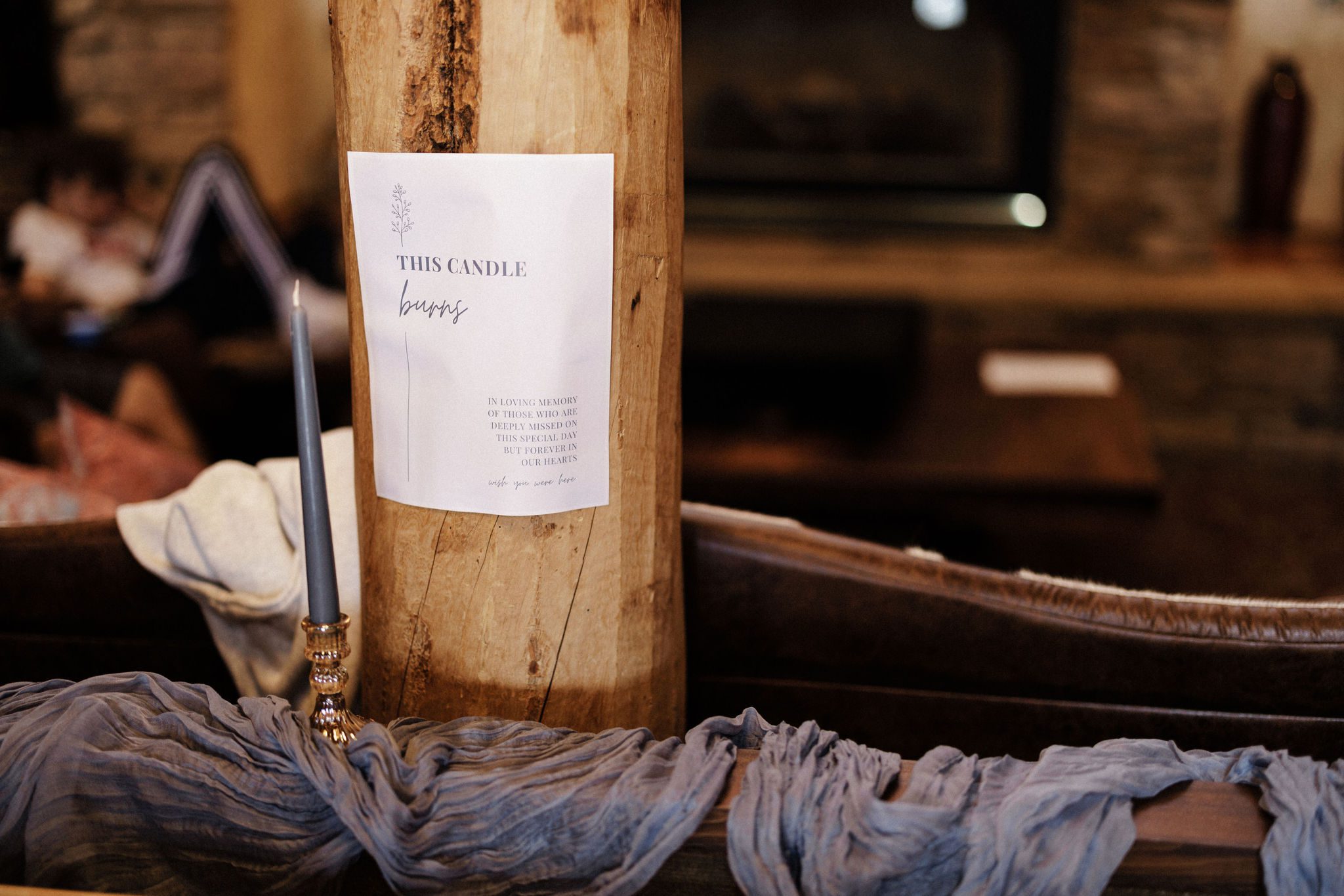 a candle and sign sit for lost loved ones after planning a wedding while grieving