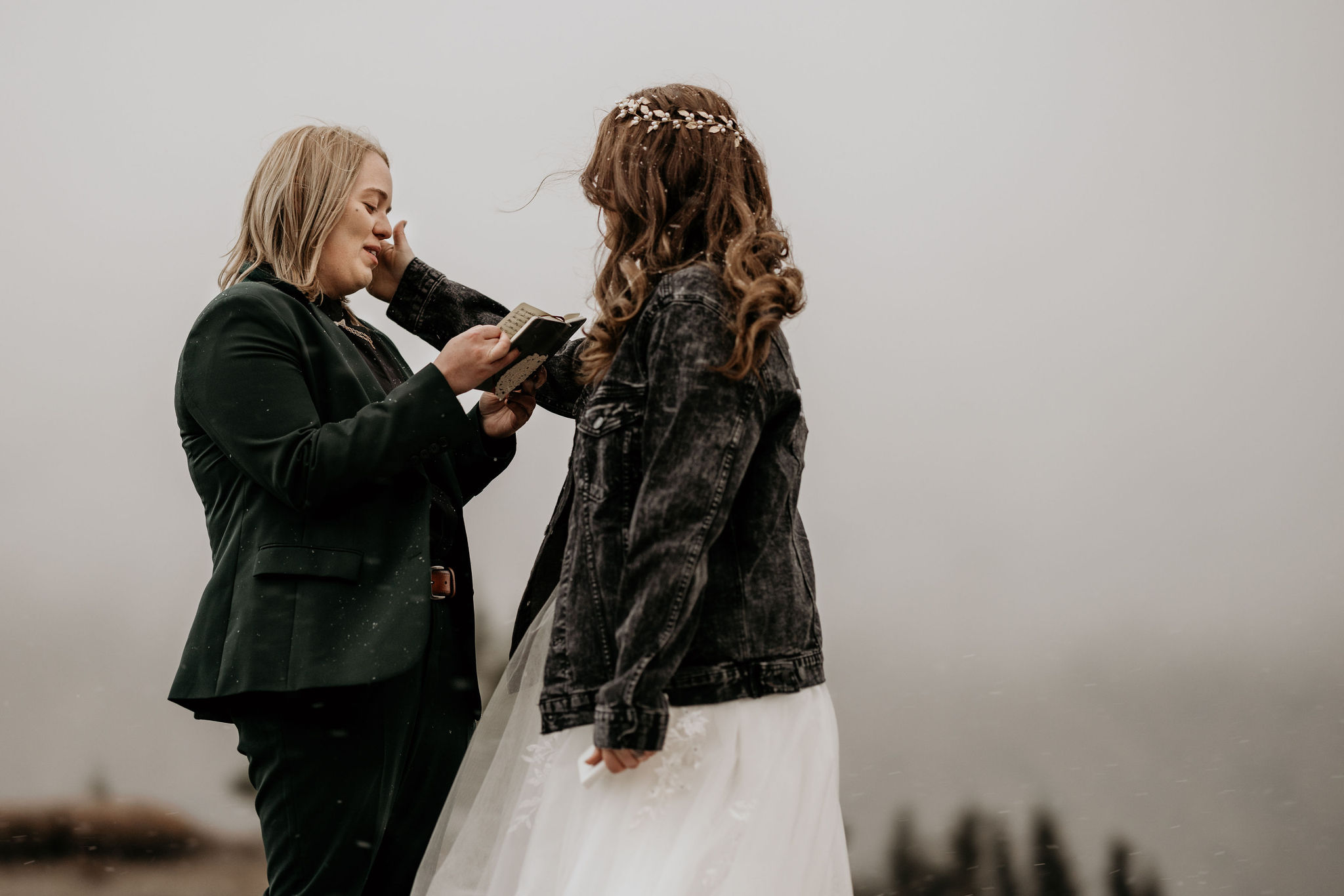newlywed couple says self-written vows and one pushes the other's hair out of the way during easygoing elopement in the mountians.