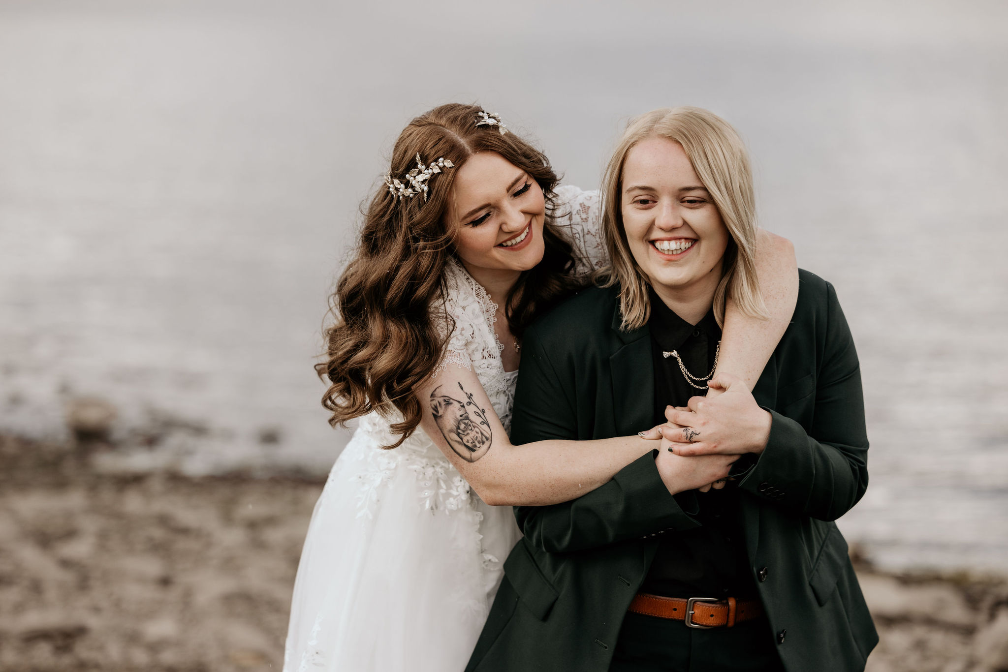 newlywed couple wrap arms around each other during simple elopement in colorado.