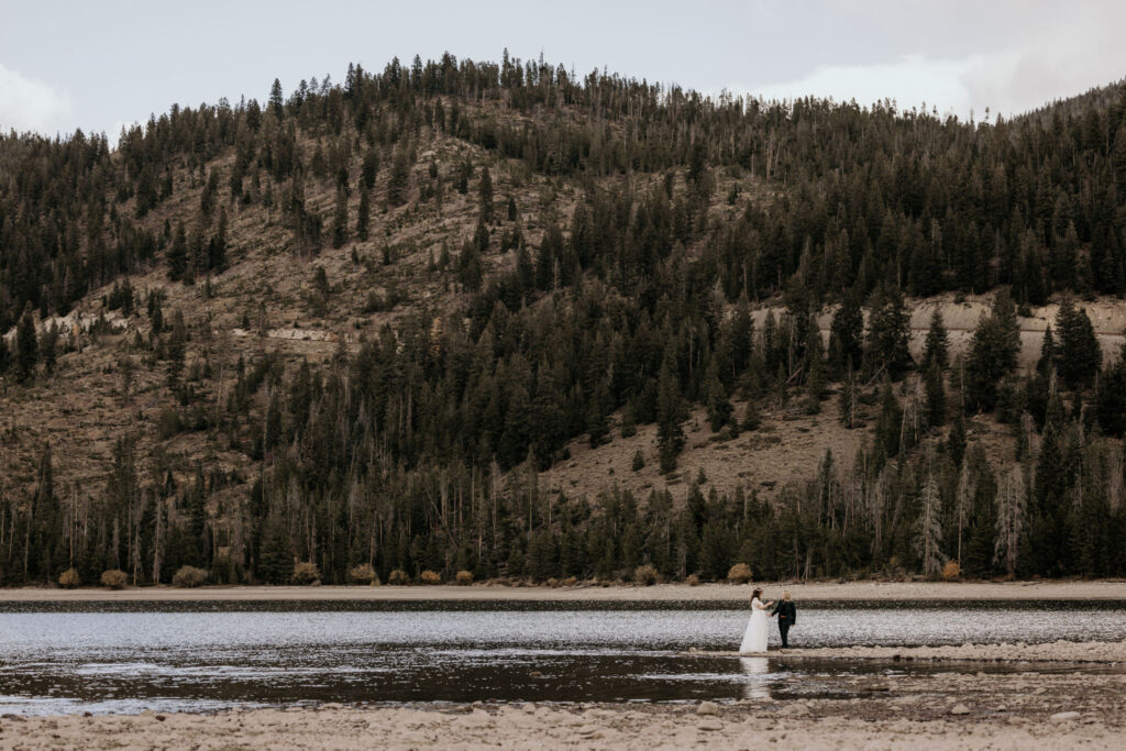 newlywed couple stands out in colorado lake during LGBTQ+ elopement in breckenridge.