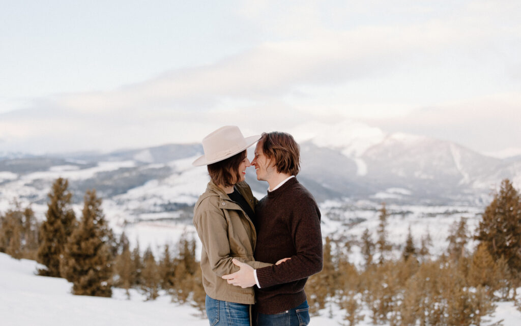 man and woman embrace at a colorado engagement location, sapphire point overlook.