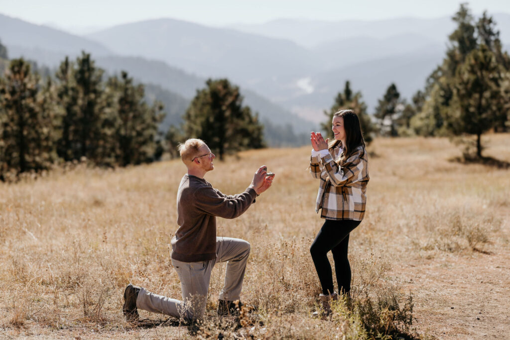 man gets on knee and proposes to woman at a colorado mountain engagement location.
