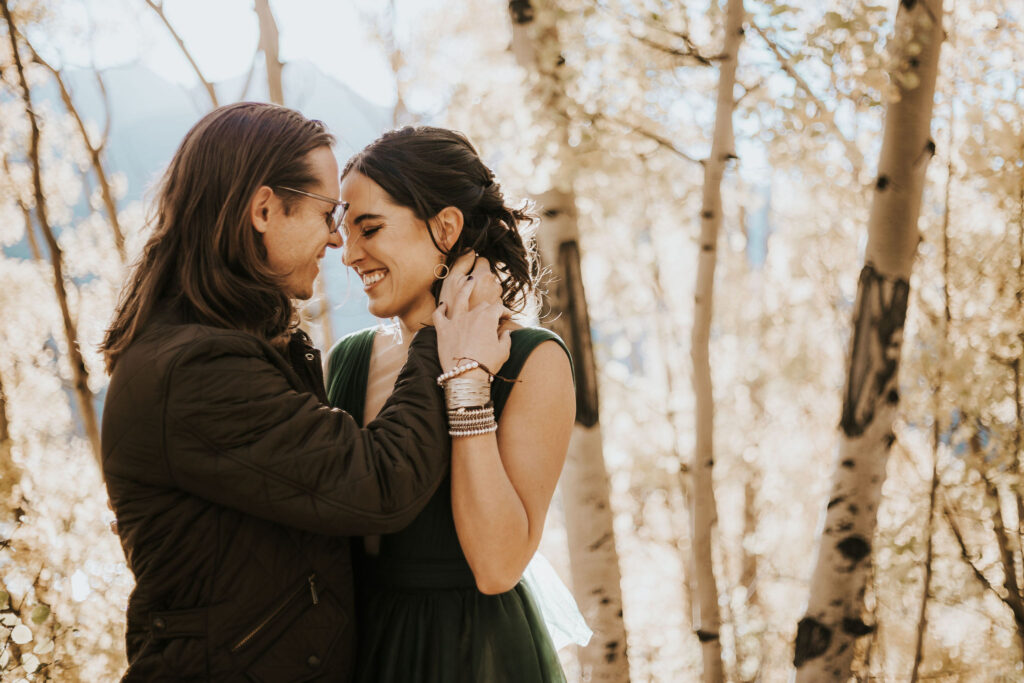 man and woman smile during couples portraits in colorado.